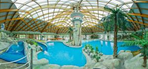 an indoor pool in a resort with a domed ceiling at KRESNIČKA in Čatež ob Savi