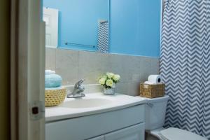 a bathroom with a sink and a mirror at Country Club Comfort in Portmore