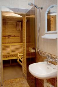 a bathroom with a sink and a shower at Galitsiya Hotel in Lviv