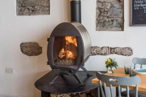 a wood fired oven sitting on a table in a room at The Newport Restaurant with Rooms in Newport-On-Tay