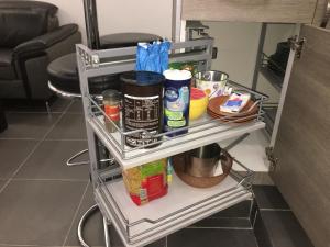 a shelf in a kitchen with food items on it at Catalans in Marseille