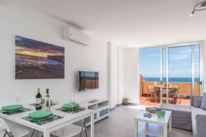 a living room with a couch and a table at Ocean View Penthouse in Gran Tarajal