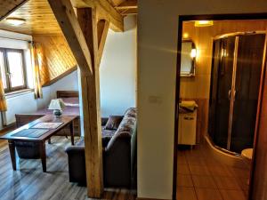 a living room with a couch and a table at Kamień Bałtyku in Debina