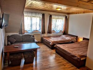 a living room with two beds and a couch at Kamień Bałtyku in Debina