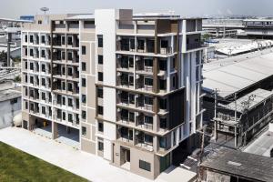 an overhead view of a white building with balconies at @S115 Residence in Samutprakarn