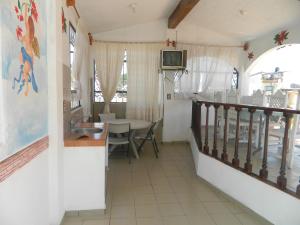 a kitchen and dining room with a sink and a table at Posada Joan Sebastian in Taxco de Alarcón