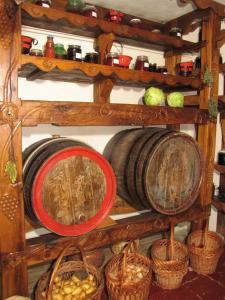 a shelf filled with wooden barrels and baskets at Pensiunea Ana Maria in Târgu-Mureş