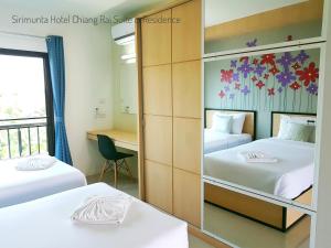 Letto o letti in una camera di Sirimunta Hotel Chiang Rai Suite & Residence