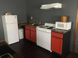 a kitchen with a white stove and a microwave at Grand Motel in Hastings