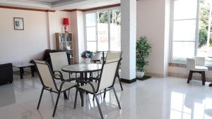 a dining room with a table and chairs at Chumphon Travelodge in Chumphon
