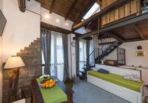 a room with two beds and a table with a bowl of fruit at Residenza Il Rustico Lago Maggiore in Gravellona Toce