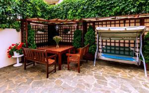 a patio with a table and chairs and a pergola at Belle Air in Sunny Beach