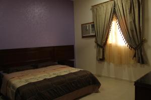 a bedroom with a bed and a window at AL Ibdaa Compound Furnished Apartments in Baish