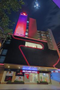 
a neon sign on the side of a building at Red Planet Manila Binondo - Multiple Use Hotel in Manila
