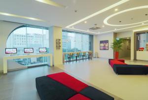 a lobby with a waiting area with red and black furniture at Red Planet Manila Binondo in Manila