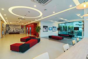 a lobby with red and black furniture in a building at Red Planet Manila Binondo in Manila