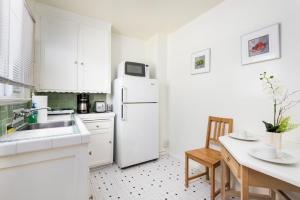 a kitchen with a white refrigerator and a table at Wilshire Motel in Los Angeles