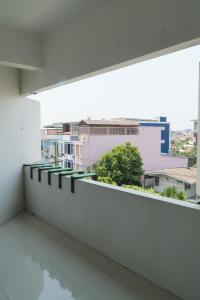 a white balcony with a view of a city at Noble House Chiangmai in Chiang Mai