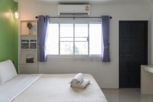 Postel nebo postele na pokoji v ubytování Noble House Chiangmai