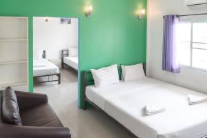 Postel nebo postele na pokoji v ubytování Noble House Chiangmai