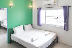 Postel nebo postele na pokoji v ubytování Noble House Chiangmai