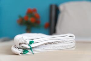 a stack of white towels sitting on a table at Noble House Chiangmai in Chiang Mai