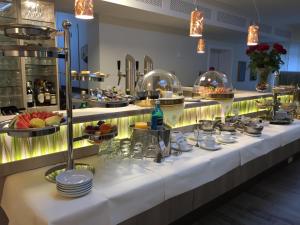 una línea de buffet con platos y tazones de comida en Das FRITZ Hotel, en Schwerin