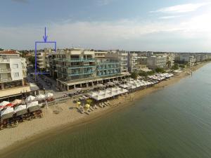 an aerial view of a beach with buildings and umbrellas at Aegean Studio by the Sea in Perea