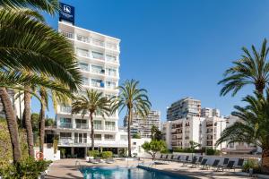 a swimming pool with palm trees and buildings at Eurostars Marivent in Palma de Mallorca