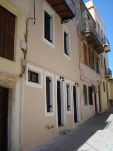 a white building with windows on a street at Old Town Apartments in Chania Town