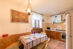 a kitchen with a table and a refrigerator at Apartment Urban garden in Rijeka