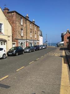 a street with cars parked on the side of the road at Beachside - North Berwick in North Berwick