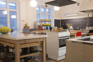 a kitchen with a white stove and a sink at Kokemäen Seurahuone in Kokemäki