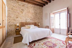 Posteľ alebo postele v izbe v ubytovaní Hotel Casa de las Cuatro Torres