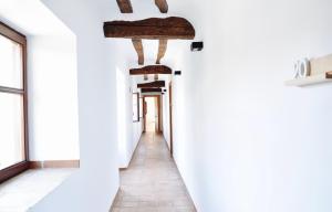 a corridor in a building with white walls and windows at Apartamentos Turísticos Rincones del Vino in Ezcaray