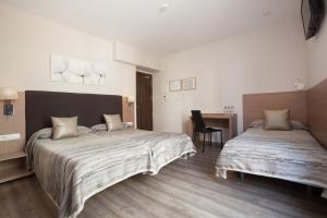 Postel nebo postele na pokoji v ubytování Hostal Centric