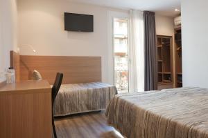 Postel nebo postele na pokoji v ubytování Hostal Centric