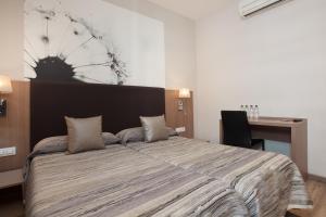 Postel nebo postele na pokoji v ubytování Hostal Centric