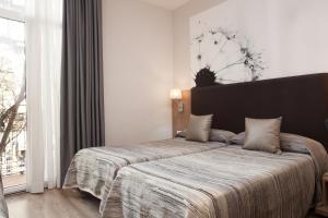 Postel nebo postele na pokoji v ubytování Hostal Centric