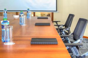 a conference room with a long table with bottles of water at Highlands Suites Hotel Apartments in Nairobi +64 photos