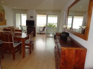 a living room with a table and a dining room at Ground Floor Sea View in Sitges