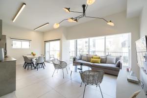 a living room with a couch and a table at Beach Apartments TLV in Tel Aviv
