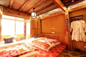 a bedroom with a bed in a room at Shangri-La King Gesar Guesthouse in Shangri-La