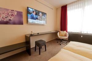 TV i/ili multimedijalni sistem u objektu Hotel Credé