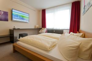 Postel nebo postele na pokoji v ubytování Hotel Credé
