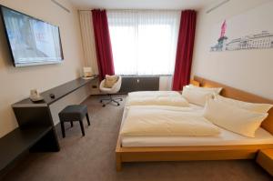 Postel nebo postele na pokoji v ubytování Hotel Credé
