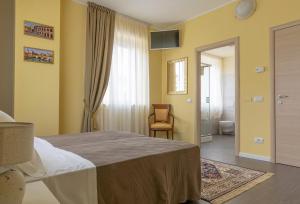A bed or beds in a room at Villa Luisa Rooms and Breakfast