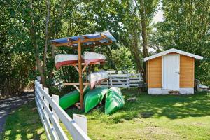 a park with a playground with a slide at Frederiksværk Camping & Hostel in Frederiksværk +88 photos