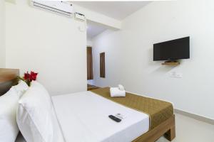 מיטה או מיטות בחדר ב-Sanctum Suites Whitefield Bangalore