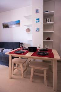 a dining room table with two chairs and wine glasses at Apartments Svijet Mora in Povljana